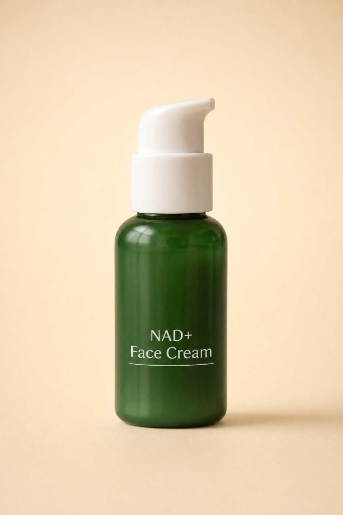 Vivo NAD+ Face Cream in a forest green pump bottle with white lettering on a warm tan surface