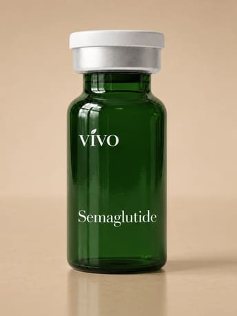 A dark green glass vial labeled Semaglutide standing on a tan background